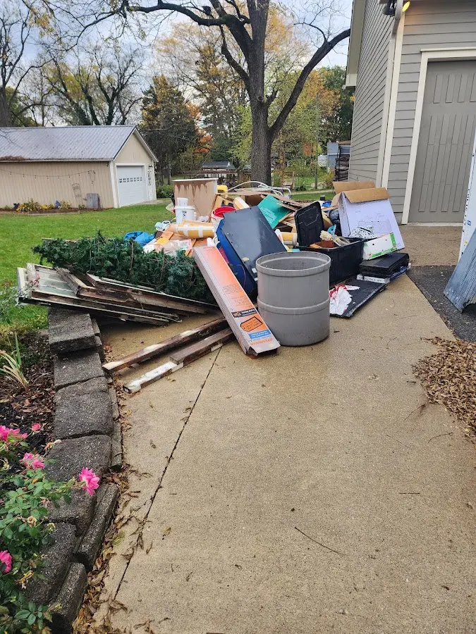 Dumpster being loaded with debris for Roofing Dumpster Rental in Fostoria